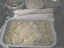 From top-to-bottom, left-to-right:
 mesclun salad with chicken and a balsamic vinegar dressing.

 marble cheesecake.

 the rectangular container which held the entree I selected: fusilli
with pumpkin in a white wine cream sauce.


Artificially brightened.
